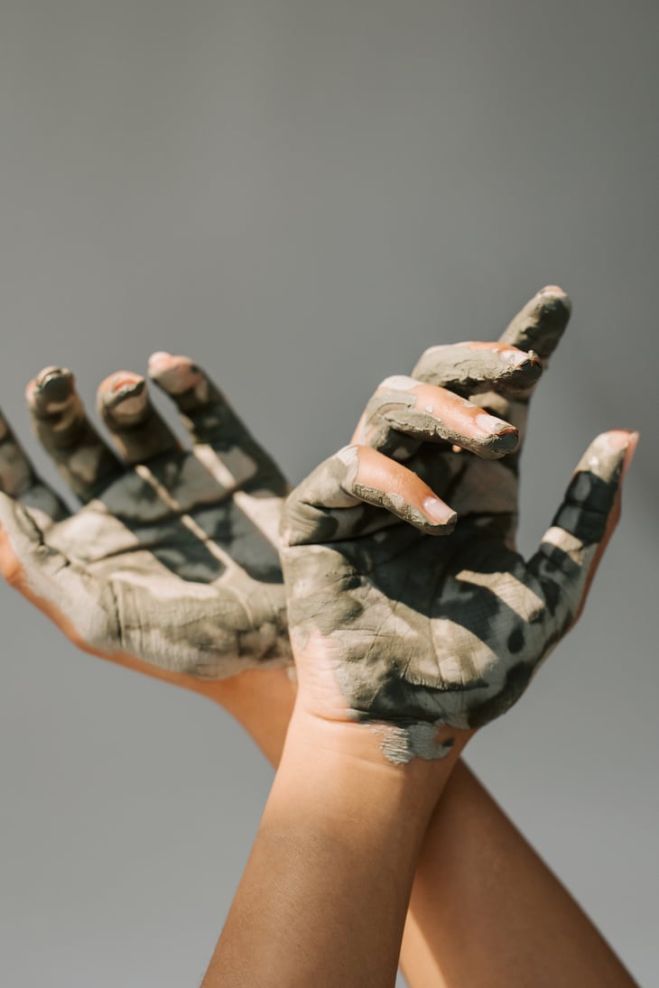 Clay Mask on Woman's Hands