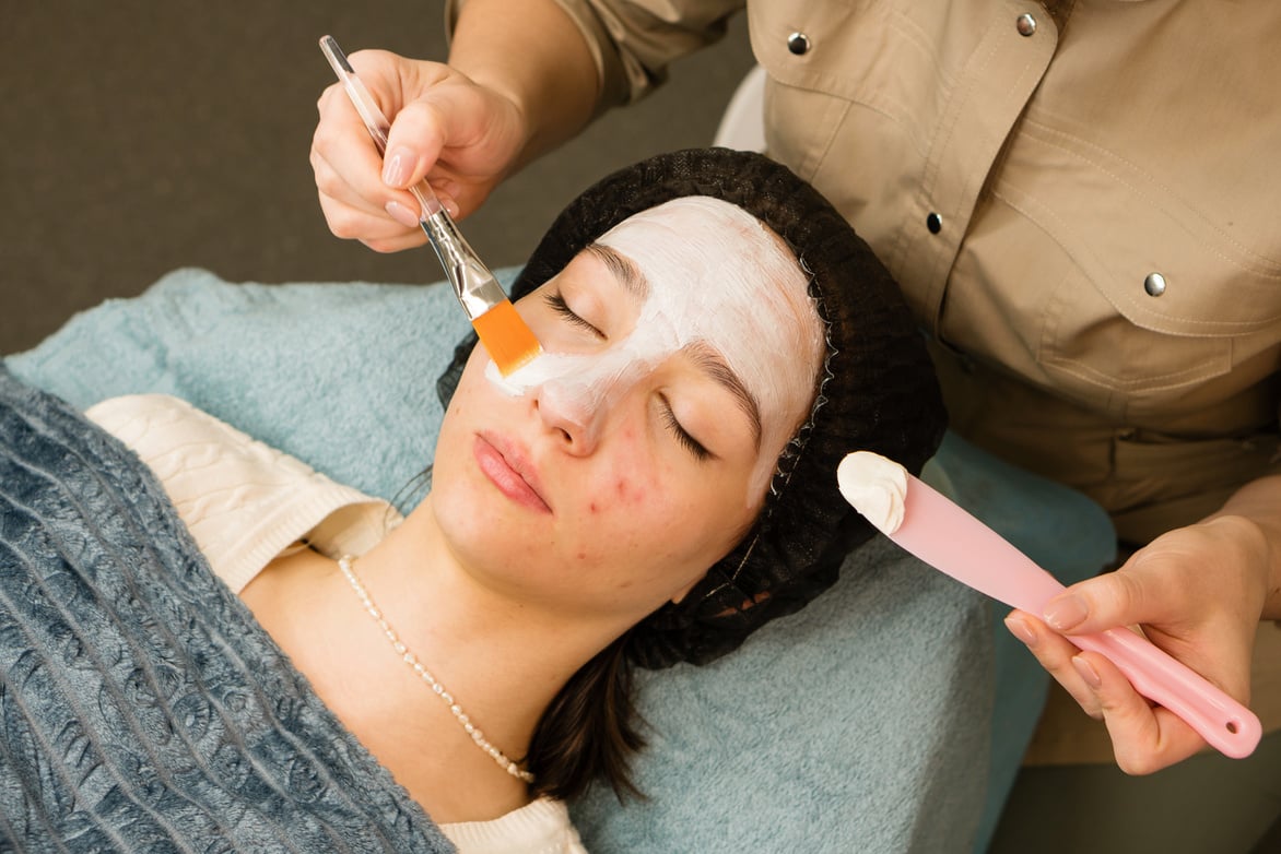 Acne Treatment at Doctor. Applying Facial Mask