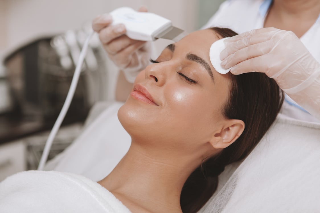 Beautiful young woman getting facial skincare treatment